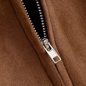 Close-up of high-quality silver metal zipper on dark brown suede jacket texture