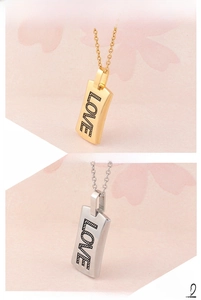 Detail of LOVE engraved square pendant necklace in 18K gold and 316L titanium steel