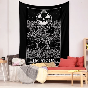 Detail of black and white Tarot Moon tapestry with wolf imagery on a bedroom wall
