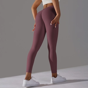 Detail view of high-waist scrunch butt yoga leggings in dark plum with elastic fabric
