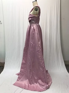 Detail of pink satin evening dress featuring a sequined waist and one-shoulder slit design