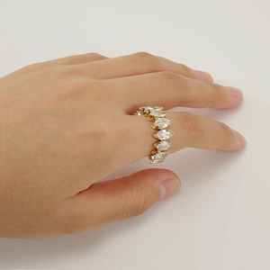 Detail of adjustable gold ring with marquise-cut zircons worn on a model's hand