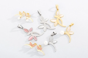 Close-up of gold and silver flower pendants with pink cat-eye stones and pearls