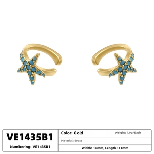 Macro shot of gold-plated starfish ear clips featuring turquoise bead inlay detail