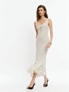 Sleeveless white polka dot maxi dress with open back and slim fit for summer styling