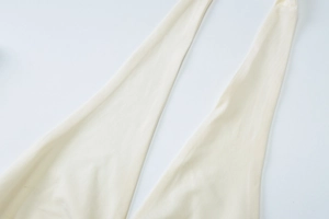 Detailed close-up of the beige knit fabric texture and strap design of the summer maxi set