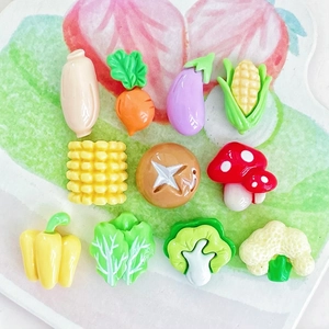 Detailed view of 11 miniature resin vegetable and food charms for DIY jewelry making