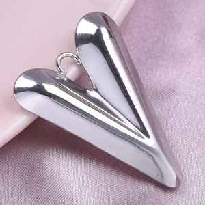 Polished silver heart pendant in 304 stainless steel on soft pink silk background