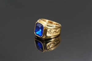Detailed side view of golden ring with blue gemstone and intricate Chinese dragon relief