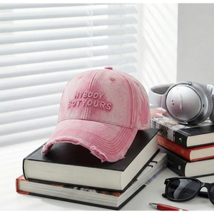 Pink washed retro baseball cap with NYBOOY embroidery on vintage books with lifestyle props