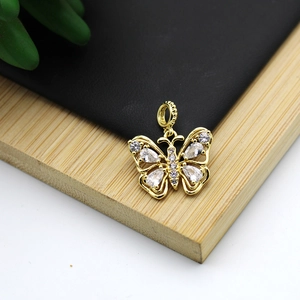 Macro shot of 18K gold plated butterfly pendant with micro-inlaid white zircons
