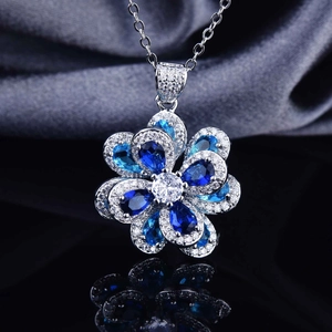 925 silver flower necklace with blue zircon crystals on elegant black silk background