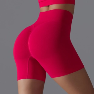 Detail view of seamless red high-waisted yoga shorts with scrunch butt lift feature