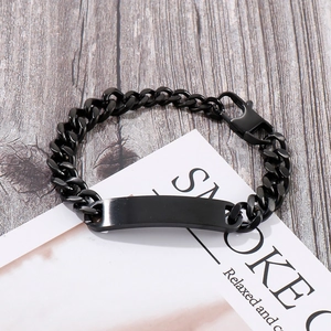 Black brushed stainless steel couple bracelet with curved ID tag on a wooden background