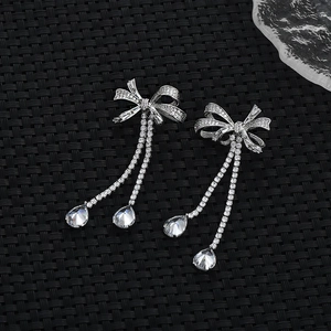Elegant silver bow earrings with zircon micro-paving and sparkling water-drop tassels