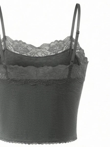 Detailed close-up of dark grey lace lingerie with adjustable straps and floral patterns