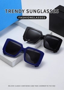 Close-up of trendy Y2K oversized square sunglasses in black and blue on geometric stands
