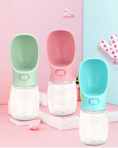 Close-up of portable pet water bottles with wide drinking troughs and paw-print buttons