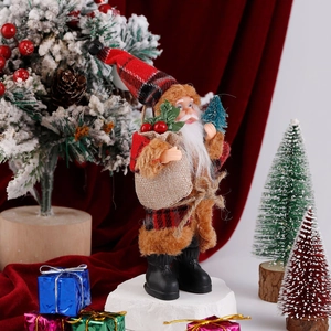 Standing Santa Claus doll with red plaid outfit and mini tree in festive setting