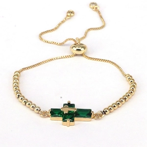 Fashionable gold cross bracelet with green stones and adjustable bead chain design