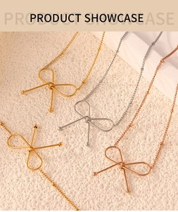 Minimalist gold and silver bow necklaces with bead chains on a beige textured surface