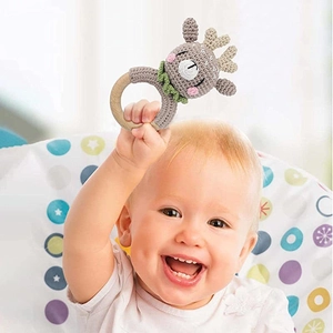Handmade crochet reindeer baby rattle with natural wooden ring for infants to grasp