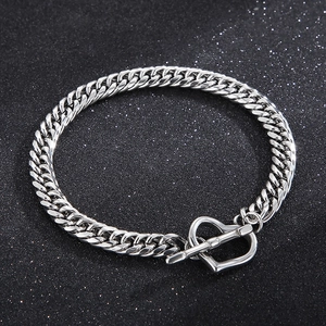 Close-up of silver titanium steel Cuban chain bracelet with heart-shaped OT toggle clasp