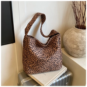 Detailed macro view of high-quality leopard print fabric texture on a large tote bag