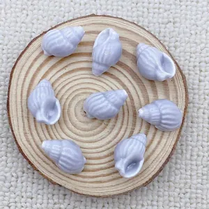 Detailed view of lavender shell-shaped ceramic beads for DIY handmade jewelry crafts