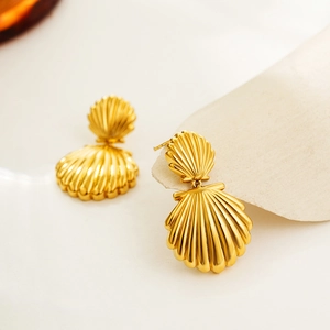 Detailed view of 18K gold plated stainless steel shell earrings with natural ocean design