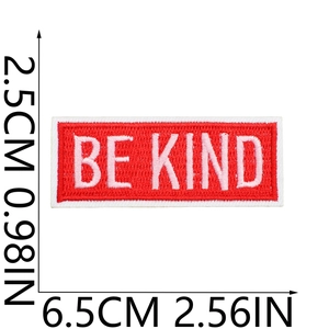 Detail of red embroidered BE KIND patch with dimensions showing precise stitching and size
