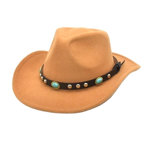 Detail of camel western cowboy hat with turquoise and metal studs on leather band