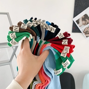 Close-up of colorful cotton skate socks with fabric labels and embroidered letters