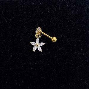 Macro view of gold stainless steel flower helix piercing with clear zircon on black velvet