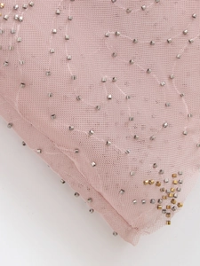 Macro detail of pink tulle dress featuring silver and gold sequin beadwork embellishments