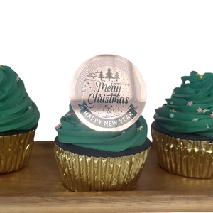 Macro detail of rose gold acrylic cupcake toppers with Merry Christmas laser engraving