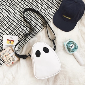 Flat lay of a white ghost-shaped PU leather crossbody bag with black eyes and strap