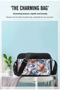 Detail of oxford cloth crossbody bag with tropical leaf print and silver zippers