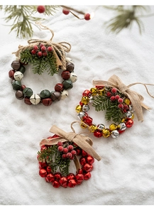 Detailed close-up of festive Christmas bell wreaths with berries and pine needles