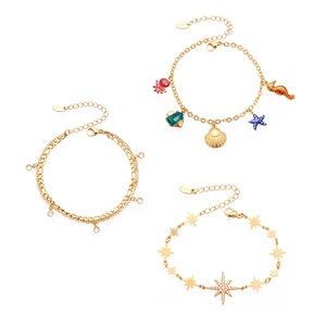 Goldenes Edelstahl-Armband-Set mit maritimen Anhängern und funkelnden Sternmotiven