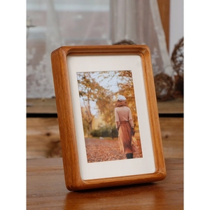 Handcrafted walnut wood picture frame with rounded corners and elegant white mat insert