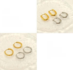 Detail of polished and electroplated gold and silver textured hoop earrings