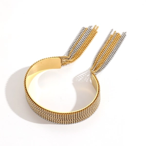 Close-up of gold and silver beaded mesh cuff bracelet with elegant fringe tassels