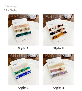 Detail view of acetate duckbill hair clip sets in various elegant marble colors