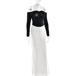 Close-up of ruched detailing on a black and white halter neck bodycon dress
