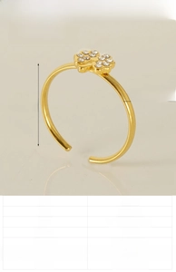 Macro detail of adjustable clover ring with gold 18K plating and pavé setting