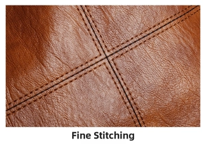 Close-up of cross-stitched seams on brown lychee pattern leather tote bag