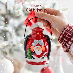 Red ceramic Santa Claus lantern with warm LED light for Christmas table decoration