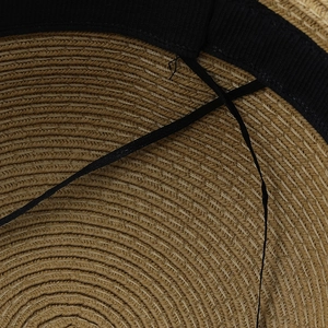 Interior view of straw sun hat featuring a black sweatband and adjustable drawstring
