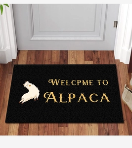 Detail of alpaca door mat with Welcome to Alpaca text on dark textured surface